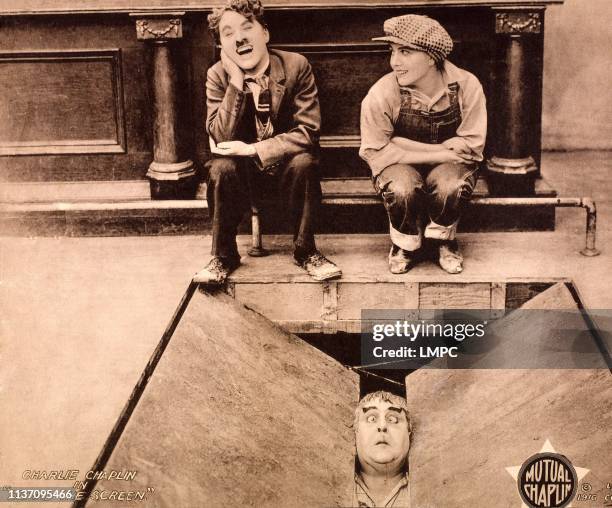 Behind The Screen, lobbycard, back: Charles Chaplin, Edna Purviance; front: Eric Campbell, 1916.