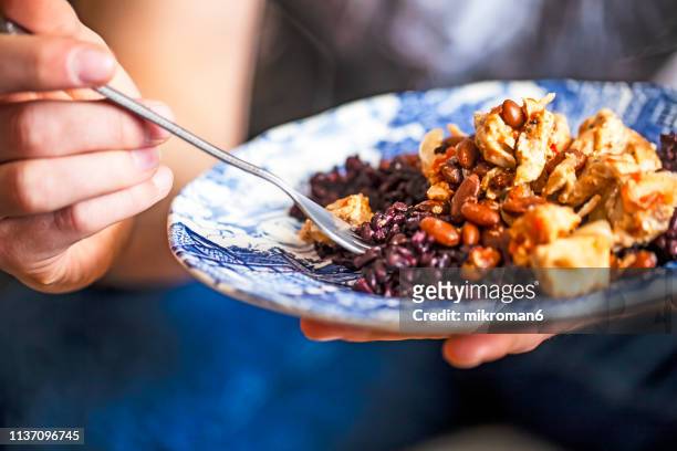 man eating homemade dinner. - bean stock pictures, royalty-free photos & images