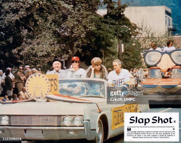 Slap Shot, lobbycard, riding in front car from left: Strother Martin, Michael Ontkean, Lindsay Crouse, Paul Newman, 1977.