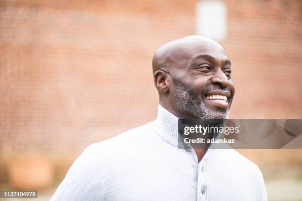 portrait of a mature senior black man - sideways glance stock pictures, royalty-free photos & images