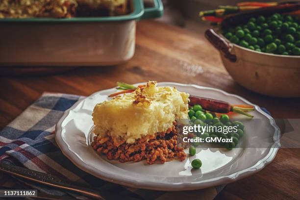preparing traditional shepard`s pie in domestic kitchen - shepherd pie stock pictures, royalty-free photos & images
