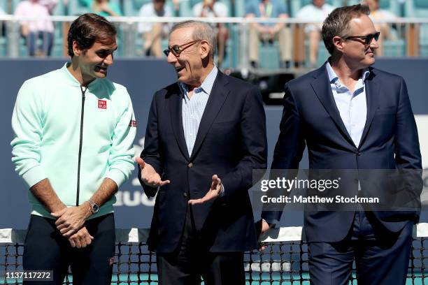 Roger Federer of Switzerland speaks to Stephen Ross at the ribbon cutting ceremony held on center court during the Miami Open Presented by Itau at...