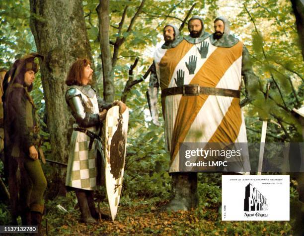 Monty Python And The Holy Grail, lobbycard, from left: Neil Innes, Eric Idle, three heads from left: Terry Jones, Graham Chapman, Michael Palin, 1975.