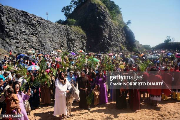 Catholic faithful take part in the reenactment of Jesus Christ's entry into Jerusalem, during the Palm Sunday procession in Cerro Nemby, in the...