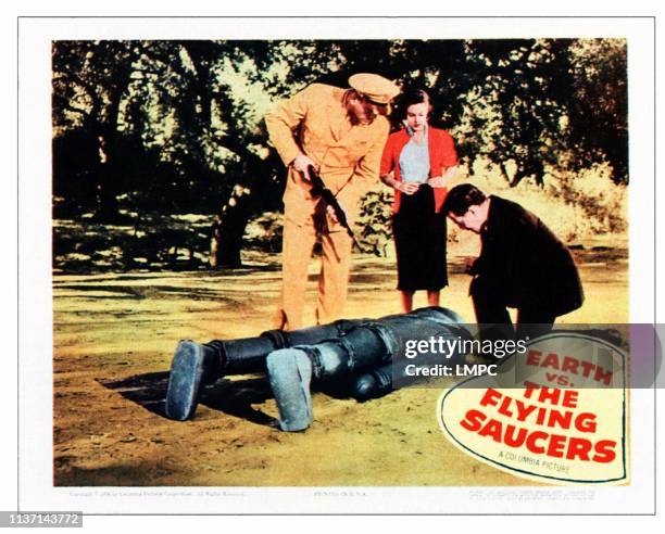 Earth Vs. The Flying Saucers, lobbycard, standing from left: Donald Curtis, Joan Taylor on lobbycard, 1956.