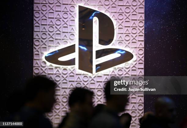 Attendees walk by the Sony PlayStation booth at the 2019 GDC Game Developers Conference on March 20, 2019 in San Francisco, California. The GDC runs...