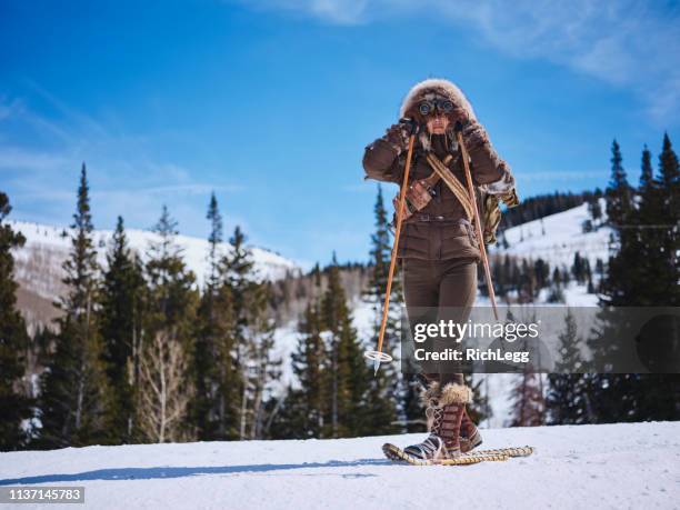 woman winter snowshoeing explorer - parka coat stock pictures, royalty-free photos & images