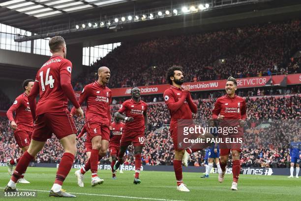 Liverpool's Egyptian midfielder Mohamed Salah celebrates with teammates after scoring their second goal during the English Premier League football...