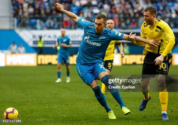 Artem Dzyuba of FC Zenit Saint Petersburg and Evgeny Gapon of FC Anji Makhachkala vie for the ball during the Russian Premier League match between FC...