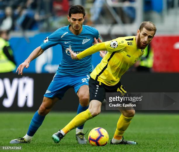 Magomed Ozdoyev of FC Zenit Saint Petersburg and Adlan Katsayev of FC Anji Makhachkala vie for the ball during the Russian Premier League match...