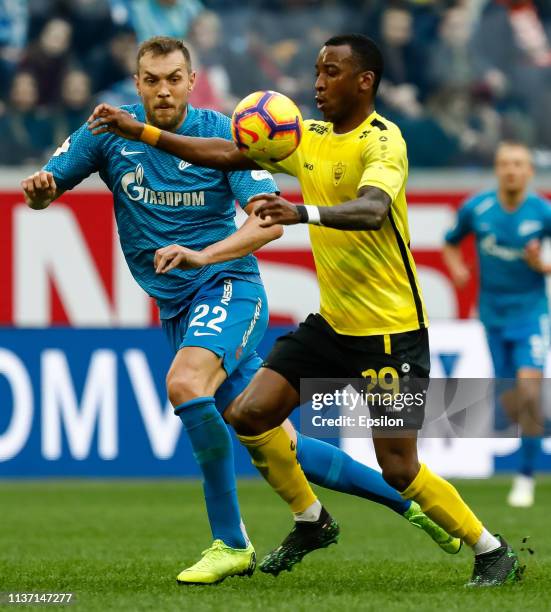 Artem Dzyuba of FC Zenit Saint Petersburg and Gael Ondoua of FC Anji Makhachkala vie for the ball during the Russian Premier League match between FC...