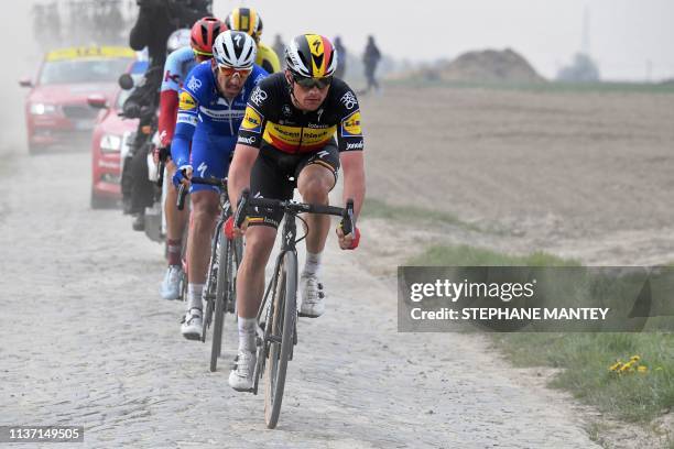 Belgium's Yves Lampaert , Belgium's Philippe Gilbert and Germany's Nils Politt ride on the Roubaix cobbled stones sector during the 117th edition of...