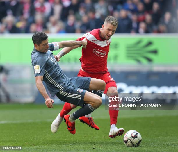 Bayern Munich's Polish forward Robert Lewandowski and Duesseldorf's German defender Andre Hoffmann vie for the ball during the German first division...