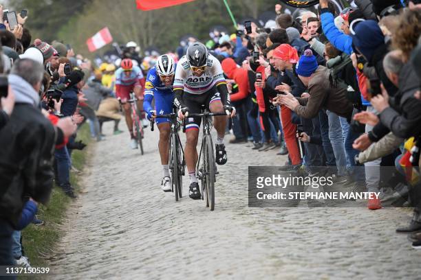 Slovakia's Peter Sagan rides followed by Belgium's Philippe Gilbert on the Roubaix cobbled stones sector during the 117th edition of the...