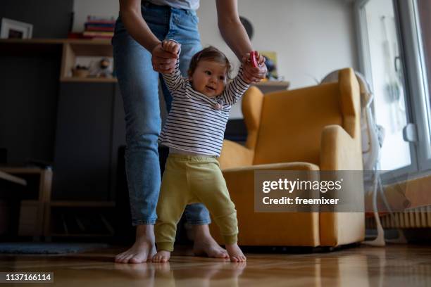 first steps baby - baby first steps stock pictures, royalty-free photos & images