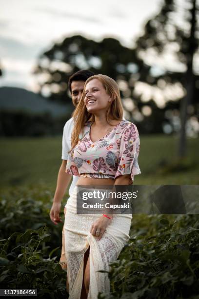 happy couple in the fields - lhasa apso stock pictures, royalty-free photos & images