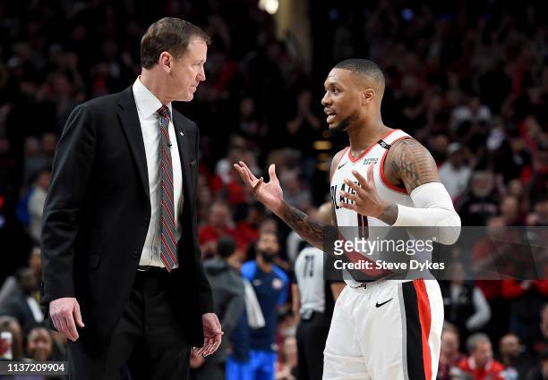 Terry Stotts of the Portland Trail Blazers speaks with Damian Lillard during the second half of the game against the Oklahoma City Thunder at the...