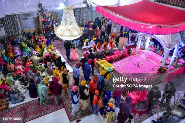 Sikh pilgrims seen attending rituals inside the gurdwara or a Sikh temple during the festival. Baisakhi, marks the Sikh New Year and is also...