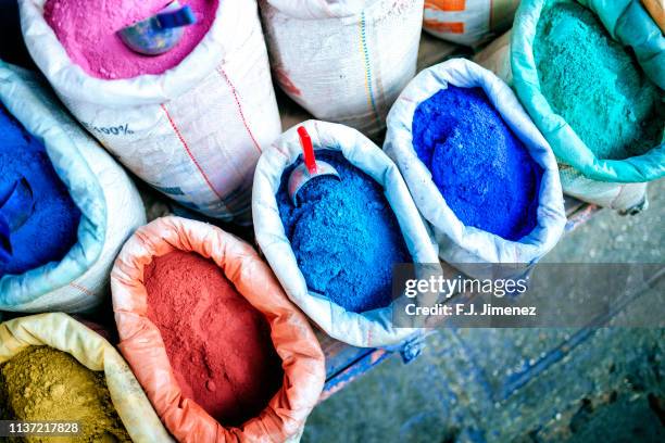 sacks of wall tint and clothes in stores in chefchaouen, morocco - färbemittel stock-fotos und bilder