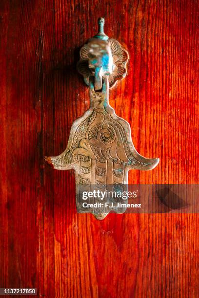 caller on door of hand of fatima - hand of fatima stock pictures, royalty-free photos & images