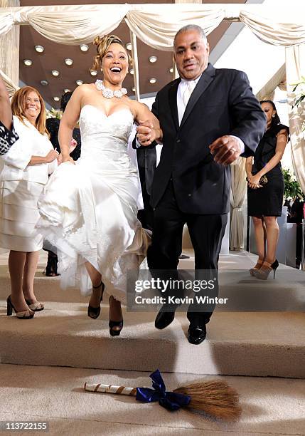 Demetrice Smith and Alvin Smith jump the broom after they renewed their wedding vows at the premiere of TriStar Pictures' "Jumping The Broom" at the...