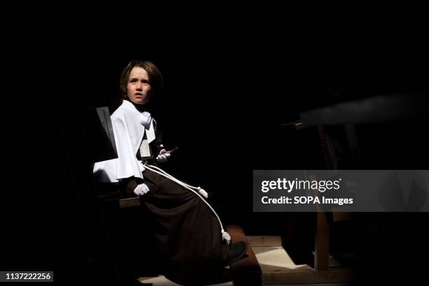 An altar server from "El Cautivo" brotherhood is seen before the Palm Sunday procession in Granada. Every year thousands of Christian believers...