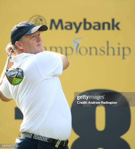 Marcus Fraser of Australia hits his tee-shot on the 18th hole on Day One of the Maybank Championship at Saujana Golf & Country Club, Palm Course on...