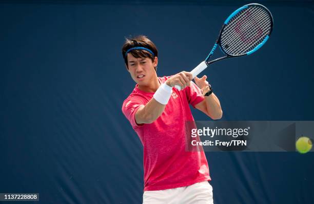 Kei Nishikori of Japan with his coach Michael Chang on the practice courts at the Hard Rock Stadium, before his first match of the Miami Open on...