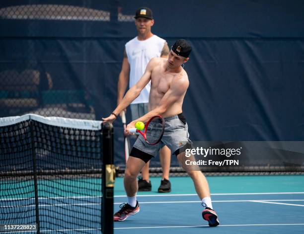 Dennis Shapovalov of Canada with his coach Rob Steckley on the practice courts at the Hard Rock Stadium, before his first match of the Miami Open on...