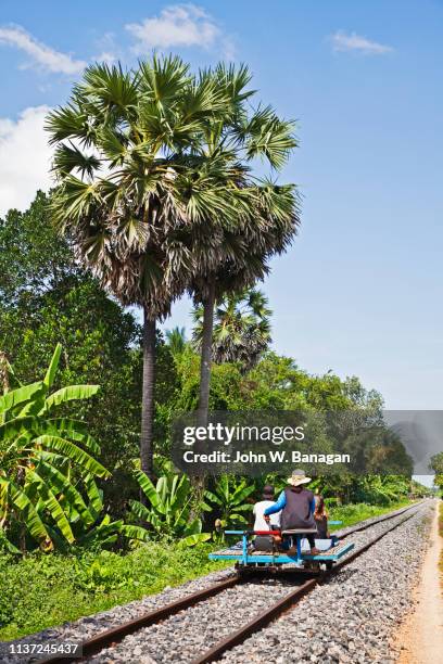 tourists ride the battambang bamboo train. battambang - camboya fotografías e imágenes de stock