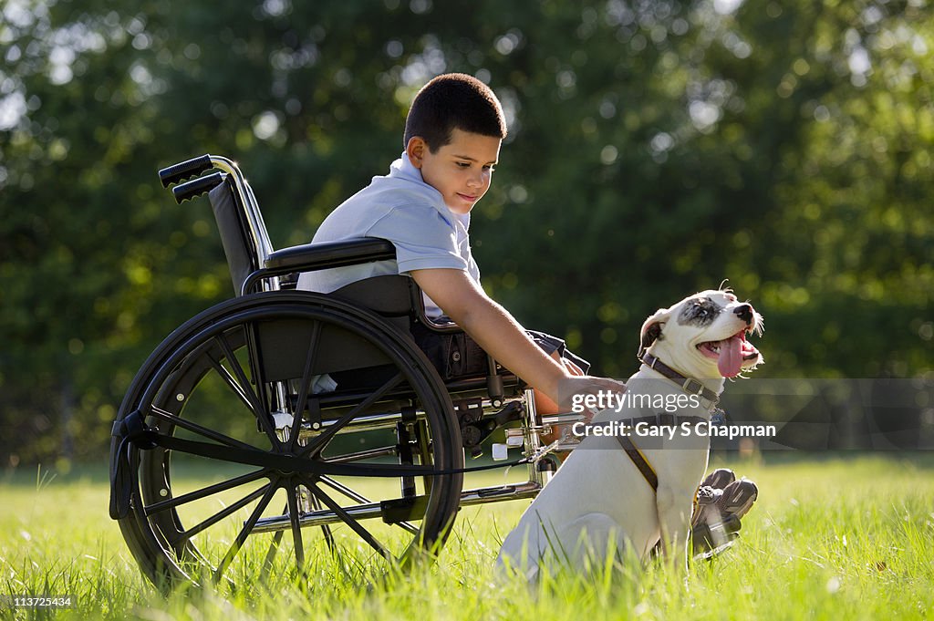 Hispanic boy, 8, in wheelchair with dog