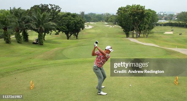 Arie Irawan of Malaysia hits his tee-shot on the first hole on Day One of the Maybank Championship at Saujana Golf & Country Club, Palm Course on...