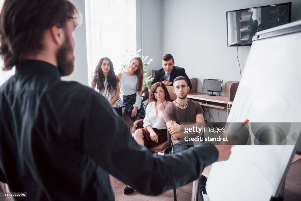 Portrait of a happy creative team of people talking in the office at the meeting.