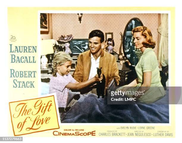 The Gift Of Love, lobbycard, from left, Evelyn Rudie, Robert Stack, Lauren Bacall, 1958.