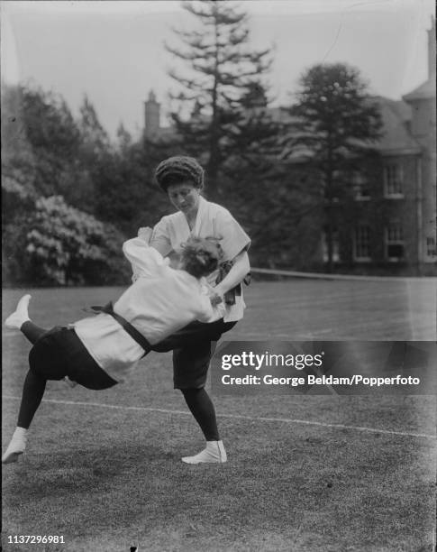 Mary Russell, 11th Duchess of Bedford , on right, demonstrates the Hiza guruma throw as she practises Jujutsu with instructor Emily Diana Watts by...