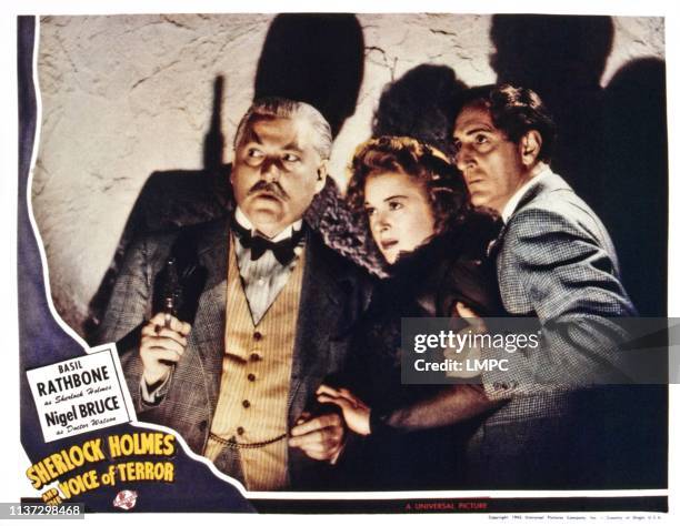 Sherlock Holmes And The Voice Of Terror, US lobbycard, from left: Nigel Bruce, Evelyn Ankers, Basil Rathbone, 1942.