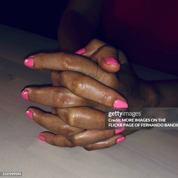 hands with pink nails at night - pink nail polish stock pictures, royalty-free photos & images