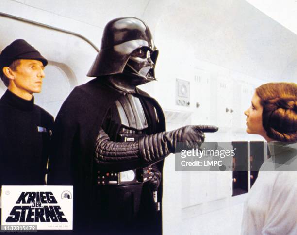 Episode Iv-a New Hope, lobbycard, German lobbycard, l-r: Al Lampert, David Prowse as Darth Vader, Carrie Fisher, 1977.