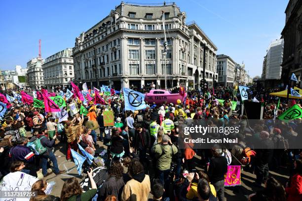 Boat is placed in the centre of the traffic junction as Environmental campaigners block Oxford Circus during a coordinated protest by the Extinction...