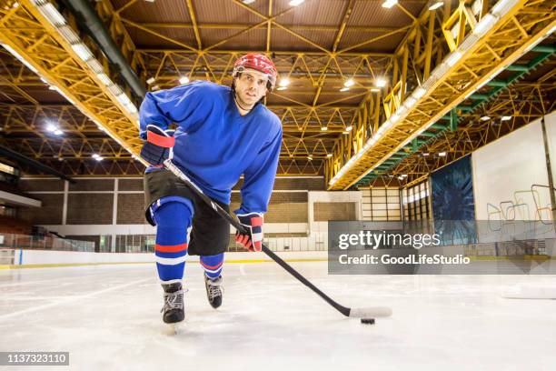 ice hockey player - hockey player on ice stock pictures, royalty-free photos & images