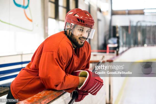 ice hockey player waiting for his chance - hockey helmet stock pictures, royalty-free photos & images