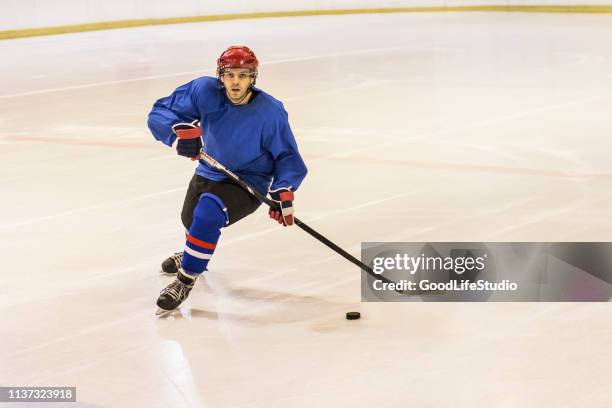 ice hockey player - hockey player on ice stock pictures, royalty-free photos & images