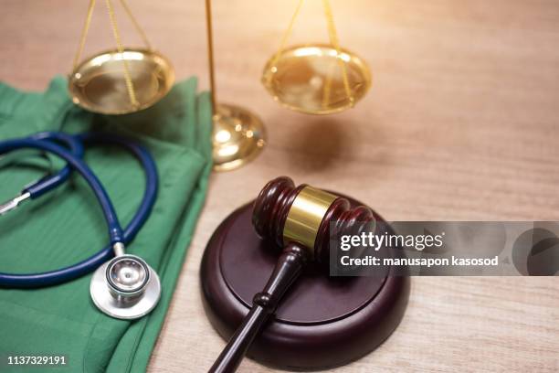 gavel and stethoscope in background. medical laws and legal concept. - medical malpractice fotografías e imágenes de stock