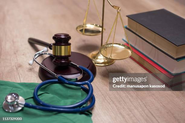 gavel and stethoscope in background. medical laws and legal concept. - medical malpractice fotografías e imágenes de stock