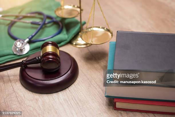 gavel and stethoscope in background. medical laws and legal concept. - medical malpractice fotografías e imágenes de stock