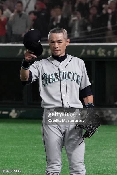 Outfielder Ichiro Suzuki of the Seattle Mariners applauds fans as he is substituted to retire from baseball during the game between Seattle Mariners...