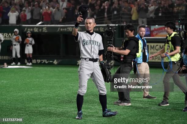 Outfielder Ichiro Suzuki of the Seattle Mariners applauds fans as he is substituted to retire from baseball during the game between Seattle Mariners...