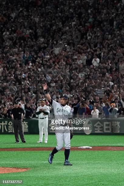 Outfielder Ichiro Suzuki of the Seattle Mariners applauds fans while he walks to the dugout as he is substituted to retire from baseball during the...