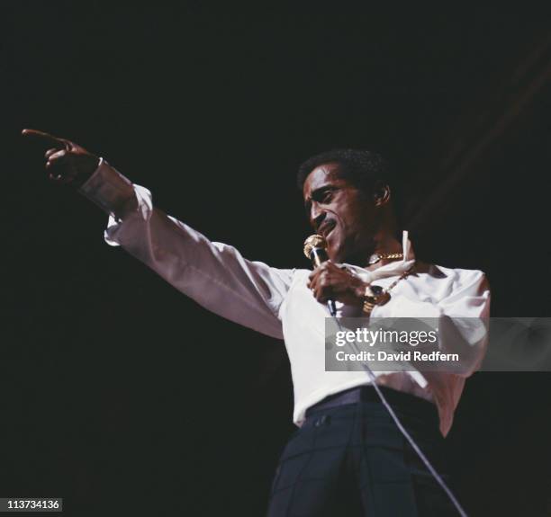 Sammy Davis, Jr. , U.S. Singer, dancer and actor, singing into a microphone during a live concert performance at the Palladium in London, England,...