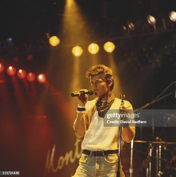 Morten Harket, singer with Norwegian group A-ha, singing into a microphone during a live concert performance at the Montreux Rock Festival, in...